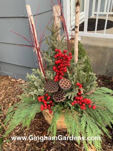 Image of a Christmas porch pot with faux red berries