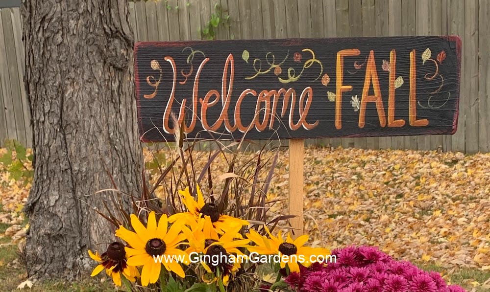 Welcome Fall sign in a pot of flowers