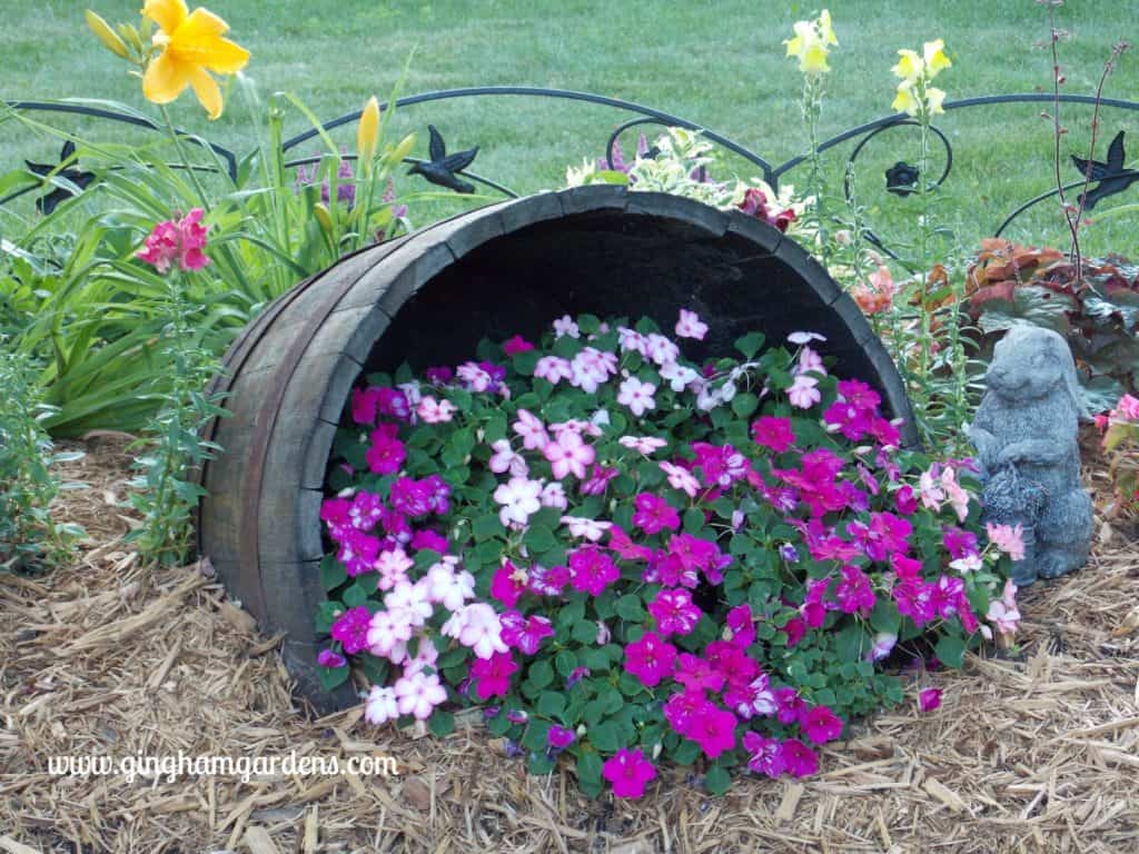 Creative Flower Container Gardening - Impatiens spilling out of a tipped wine barrel.