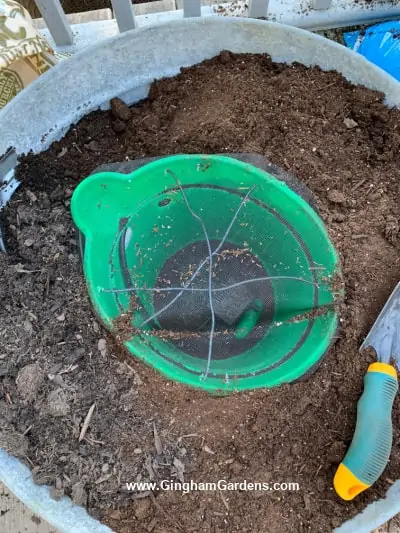 DIY Vintage Pump Fountain and Planter - Process - filling the galvanized planter with soil