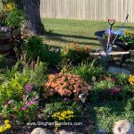 Garden in the Fall with wheelbarrow and gardening tools and supplies