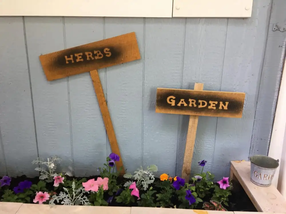 Garden signs that say herbs and garden
