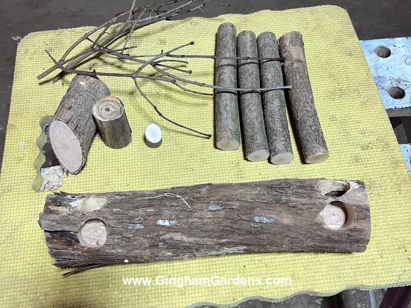 Logs with drill holes for DIY decorative deer made from tree branches