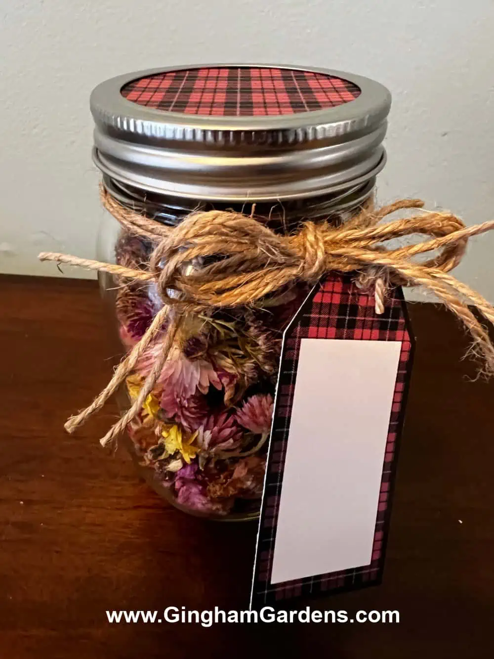 A jar of homemade potpourri with a matching gift tag and jar topper.