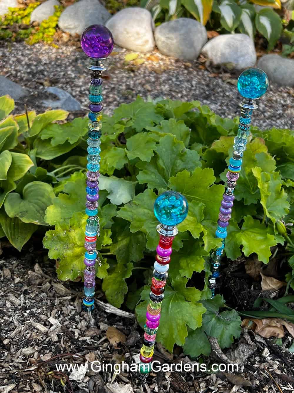 Glass bead garden stakes in a shade garden.